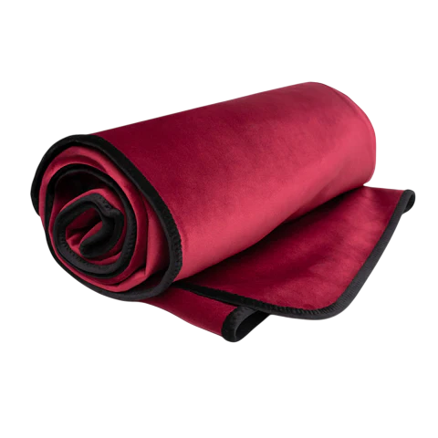 Rolled up merlot king size waterproof microvelvet throw blanket with black trim.