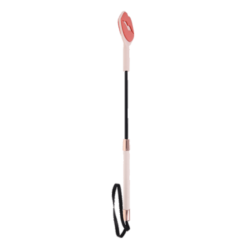 A pink silicone lip-shaped spanking whip with a faux leather handle and rose gold accents.