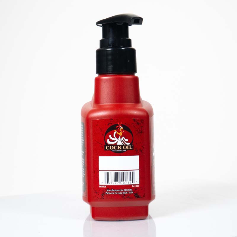 Red bottle of Cock Oil lubricant with a black pump top.