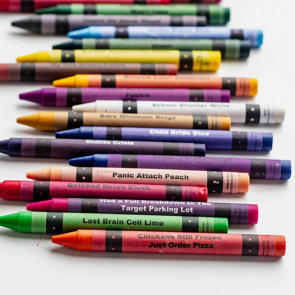 A collection of adult coloring crayons with humorous names like "Midlife Crisis" and "Panic Attach Peach."