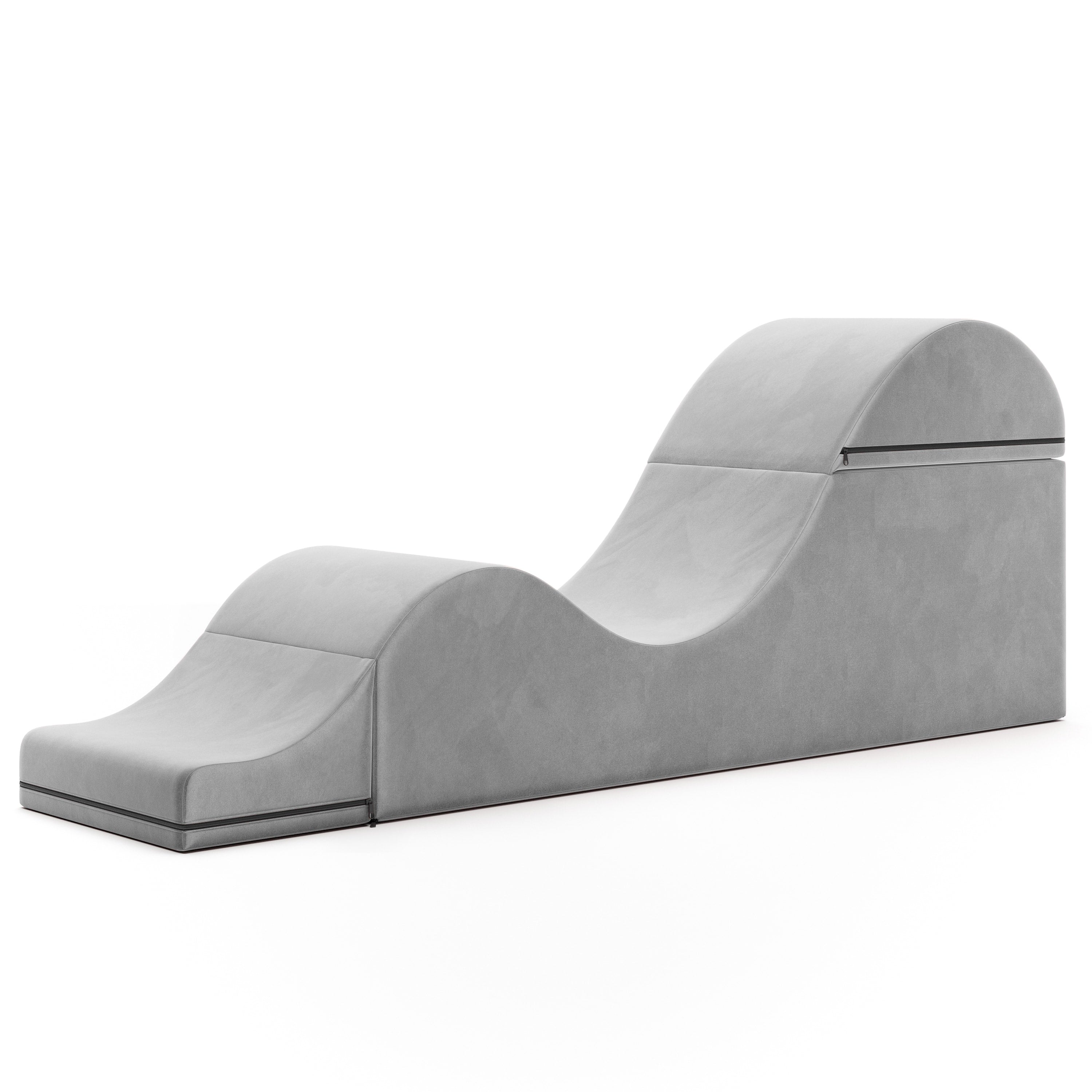 Grey velvet convertible sex chair and bed bench with a curved design.