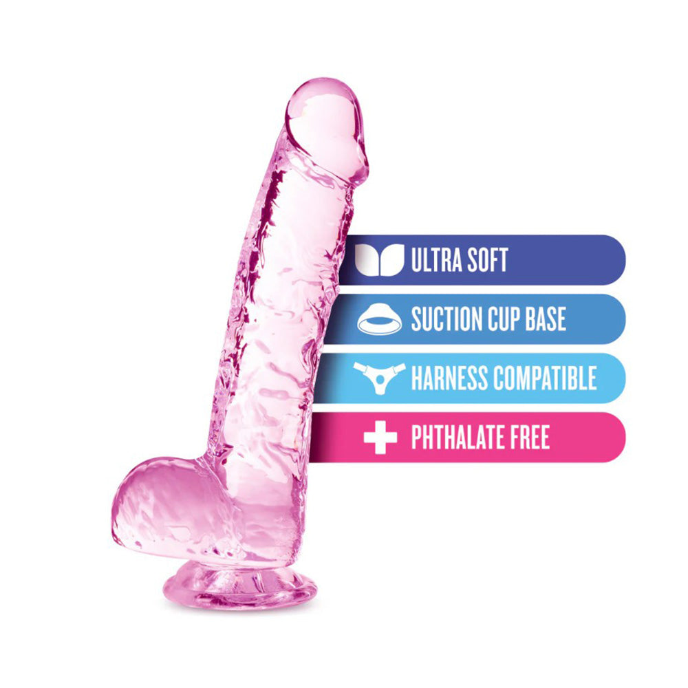 6-inch rose blush crystalline TPE dildo with suction cup base and harness compatibility labels.