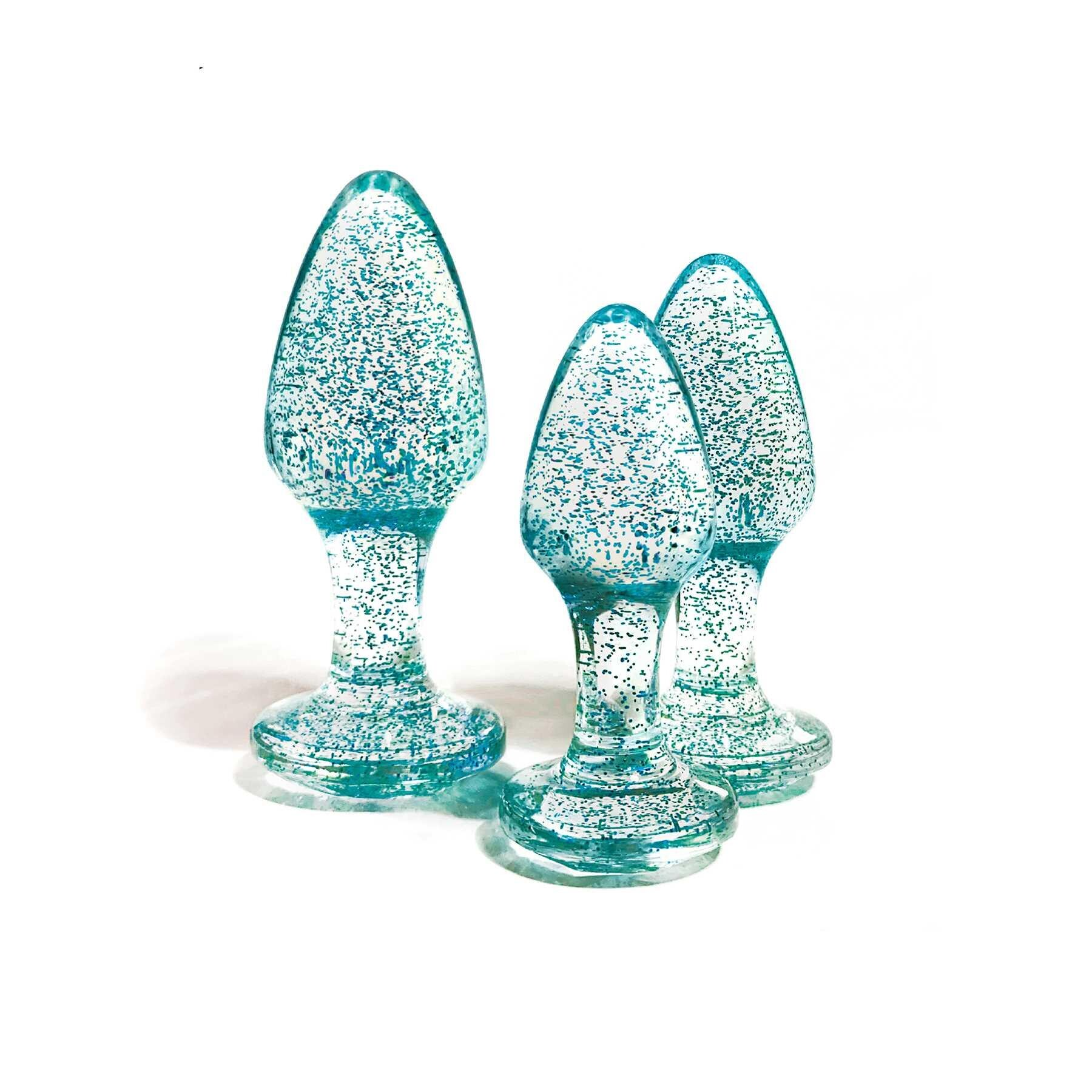 Three blue glitter anal plugs of varying sizes.