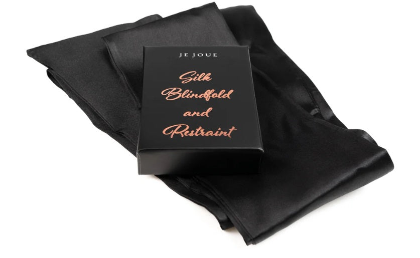 Black silk blindfold and restraint set in a box.