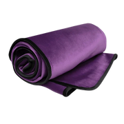 A rolled purple microvelvet throw blanket with a black edge.