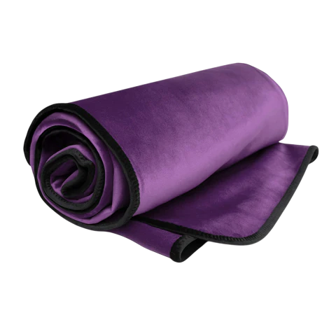 A rolled purple microvelvet throw blanket with a black edge.
