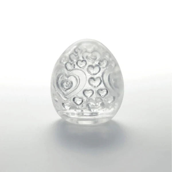 A clear, egg-shaped pleasure sleeve with embossed hearts.