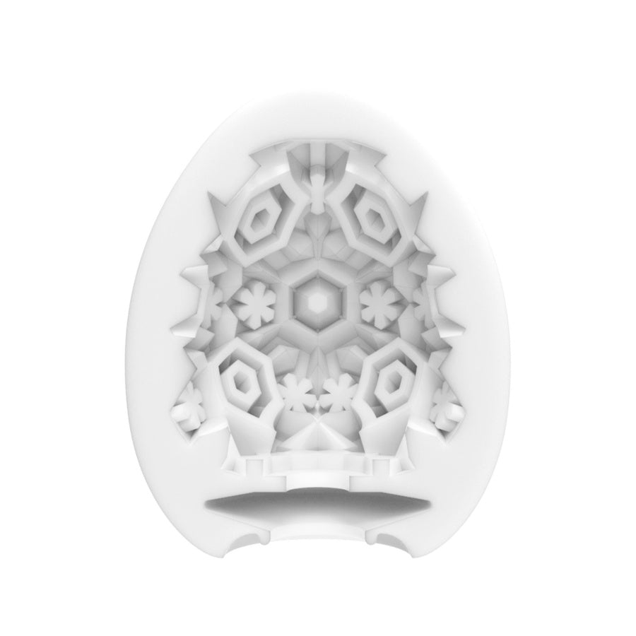 White silicone egg-shaped masturbator with intricate snowflake pattern.