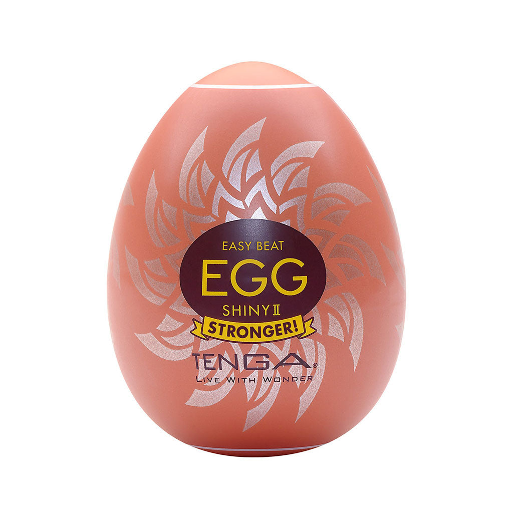 Tenga Shiny II male masturbator egg with a sun-shaped design.