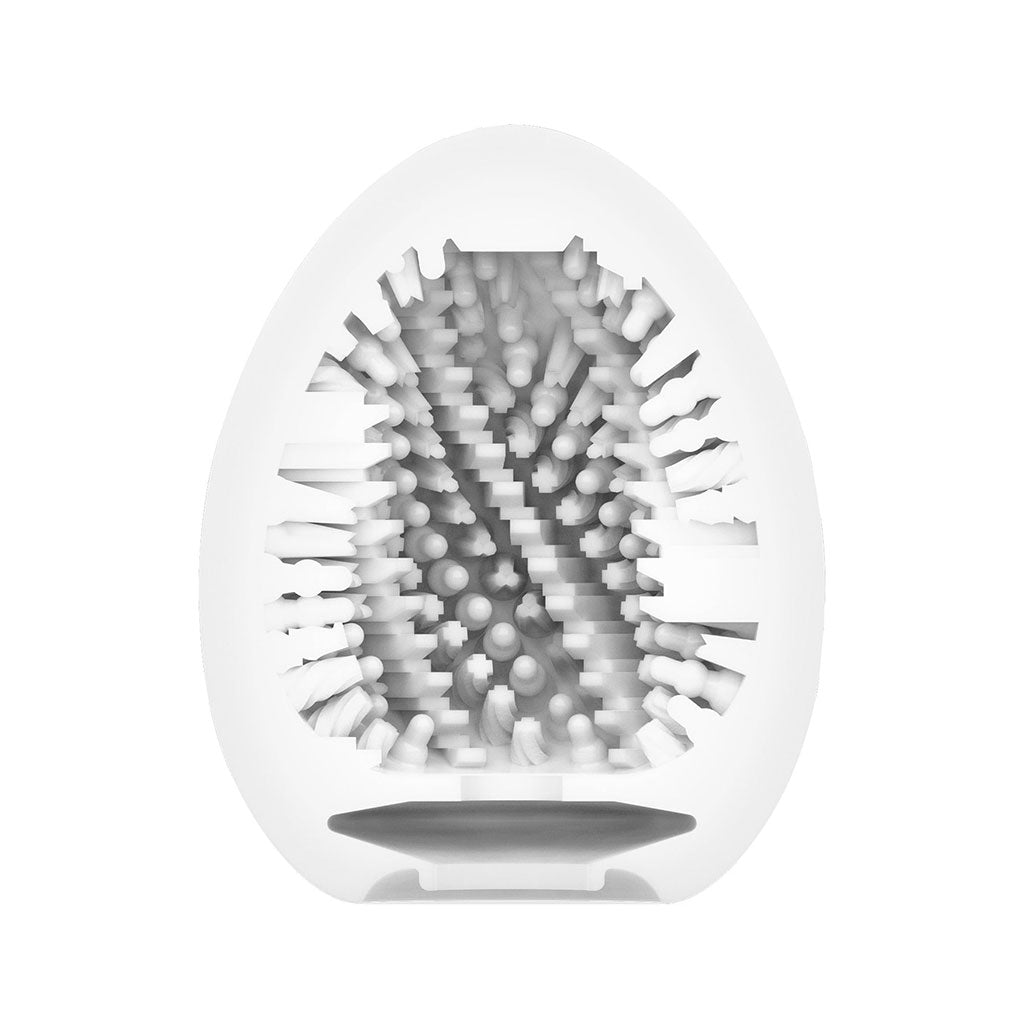 A white, egg-shaped male masturbator with internal textured patterns.