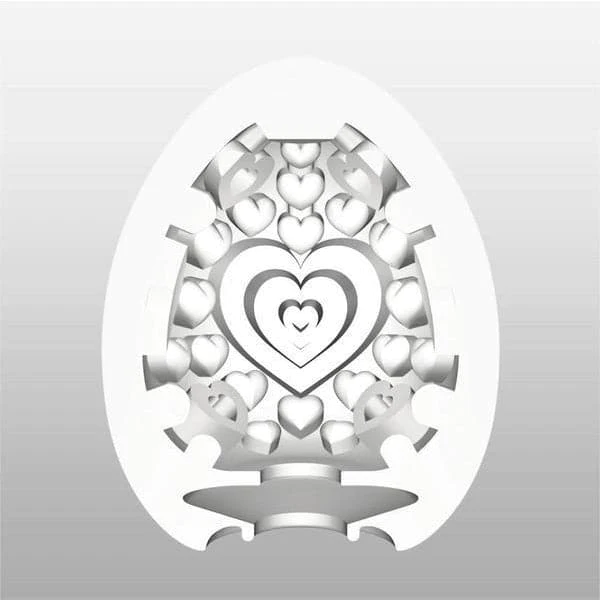 White egg-shaped pleasure sleeve with heart cutouts and a central heart design.