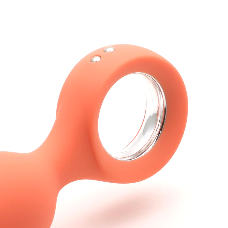Orange silicone butt plug with a clear ring and two small buttons.