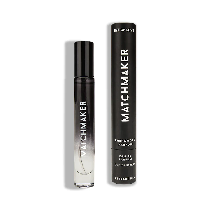 A black and clear rollerball bottle of Matchmaker Pheromone Parfum next to its black cylindrical packaging.