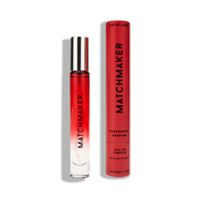 A red bottle of Matchmaker pheromone parfum with its matching red cylindrical case.