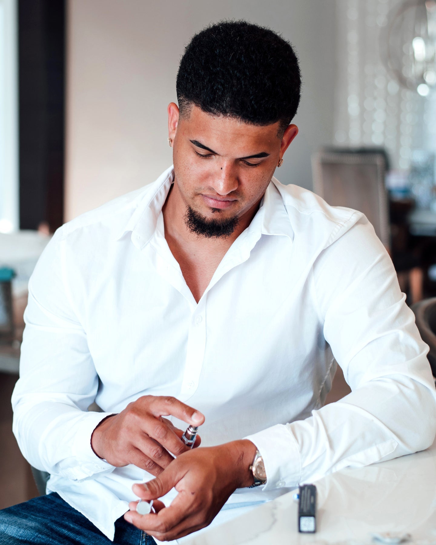 Man applying lemongrass and sandalwood pheromone cologne.