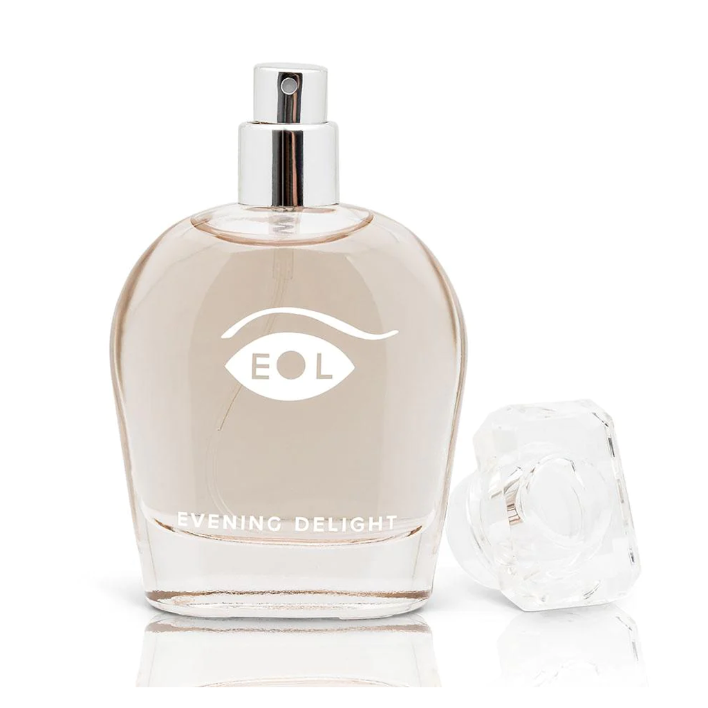 A clear glass perfume bottle with a silver spray top and a faceted cap, labeled "EOL Evening Delight".