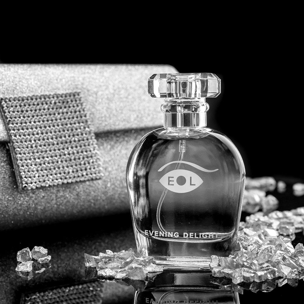 Evening Delight pheromone perfume for women in a clear glass bottle with a crystal cap.