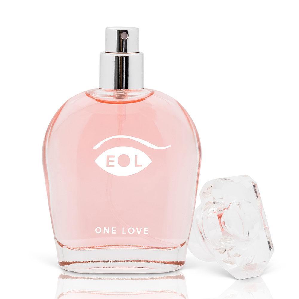 A pink glass bottle of One Love perfume with a silver spray top and a clear cap.