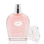 A pink glass bottle of One Love perfume with a silver spray top and a clear cap.