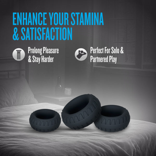 Textured silicone cock rings in three sizes on a bed.