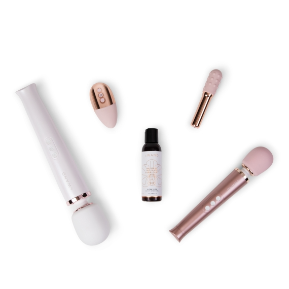 A white wand, a pink and gold vibrator, a small bottle of lubricant, and a pink and gold attachment.