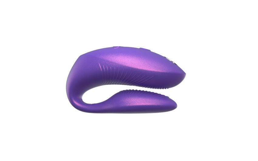 Purple couples vibrator with a curved design and textured surface.