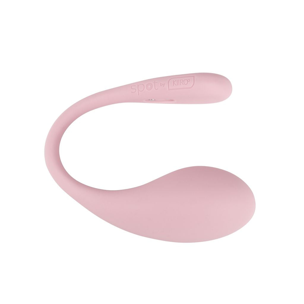 A pink, curved wearable egg vibrator with "spot by Kiiroo" logo.