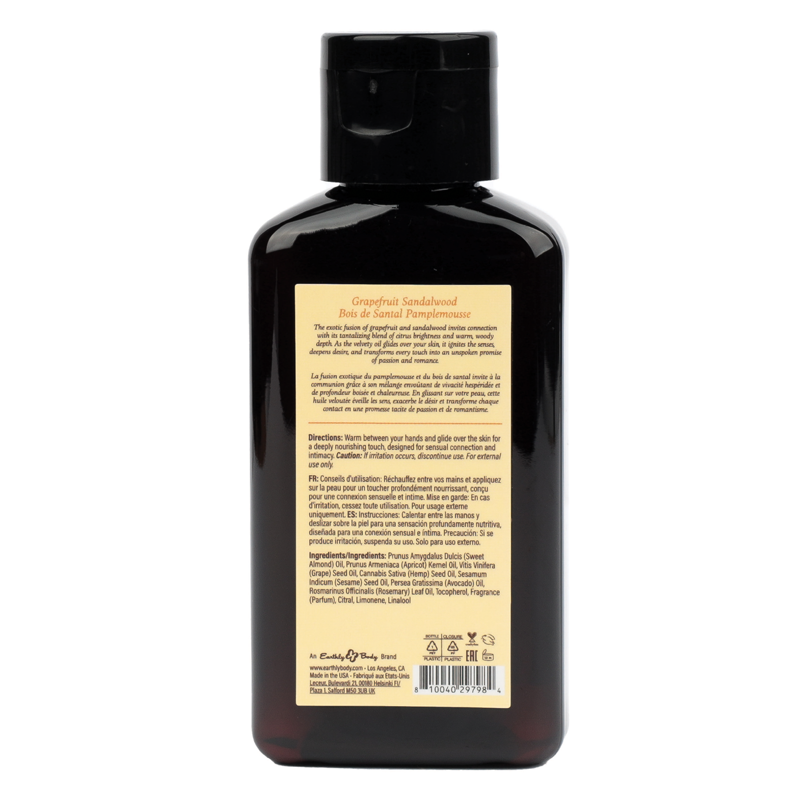 A dark bottle of Grapefruit Sandalwood massage oil with product information.