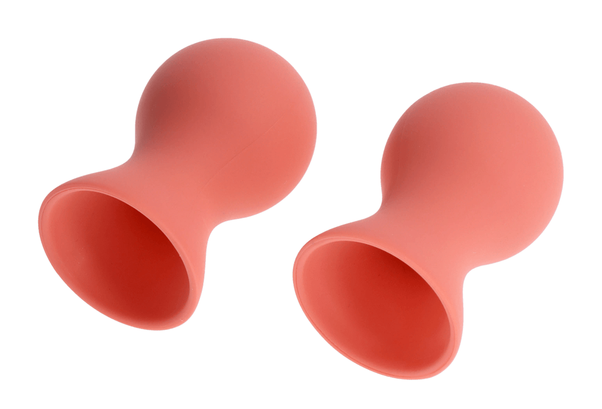 Two pink silicone nipple suckers with a bulbous top and flared opening.