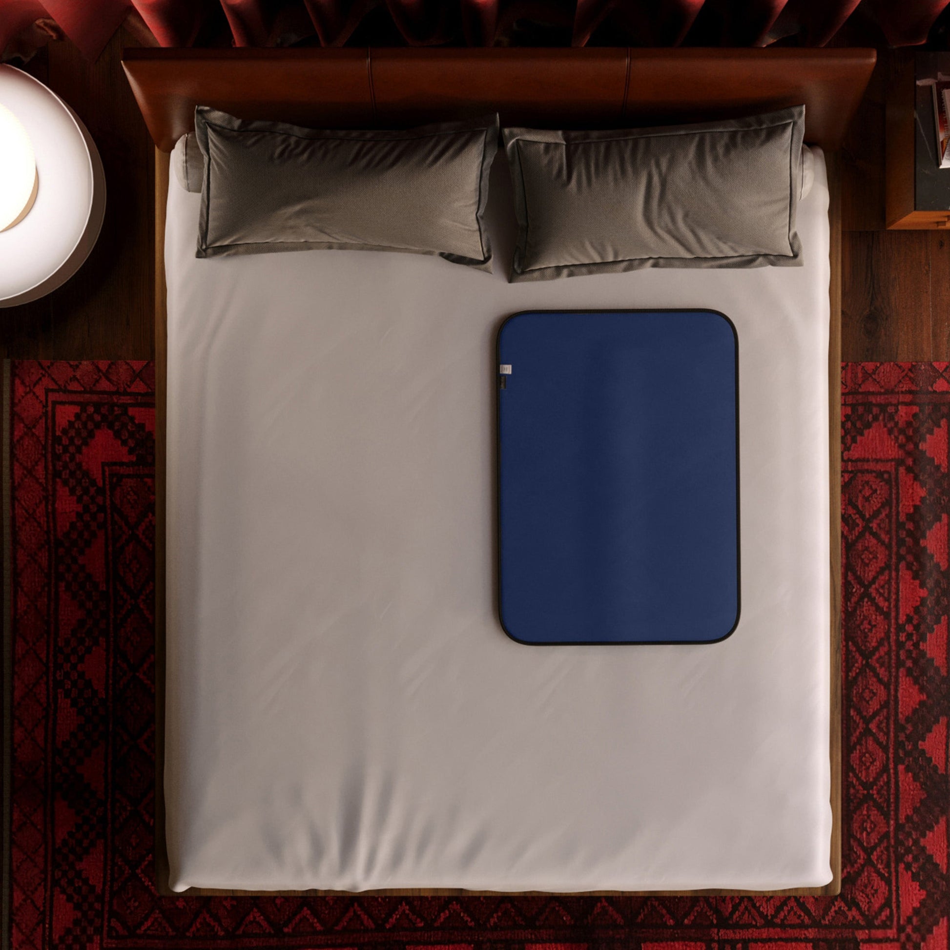 Royal blue waterproof microvelvet sex throw blanket on a bed.