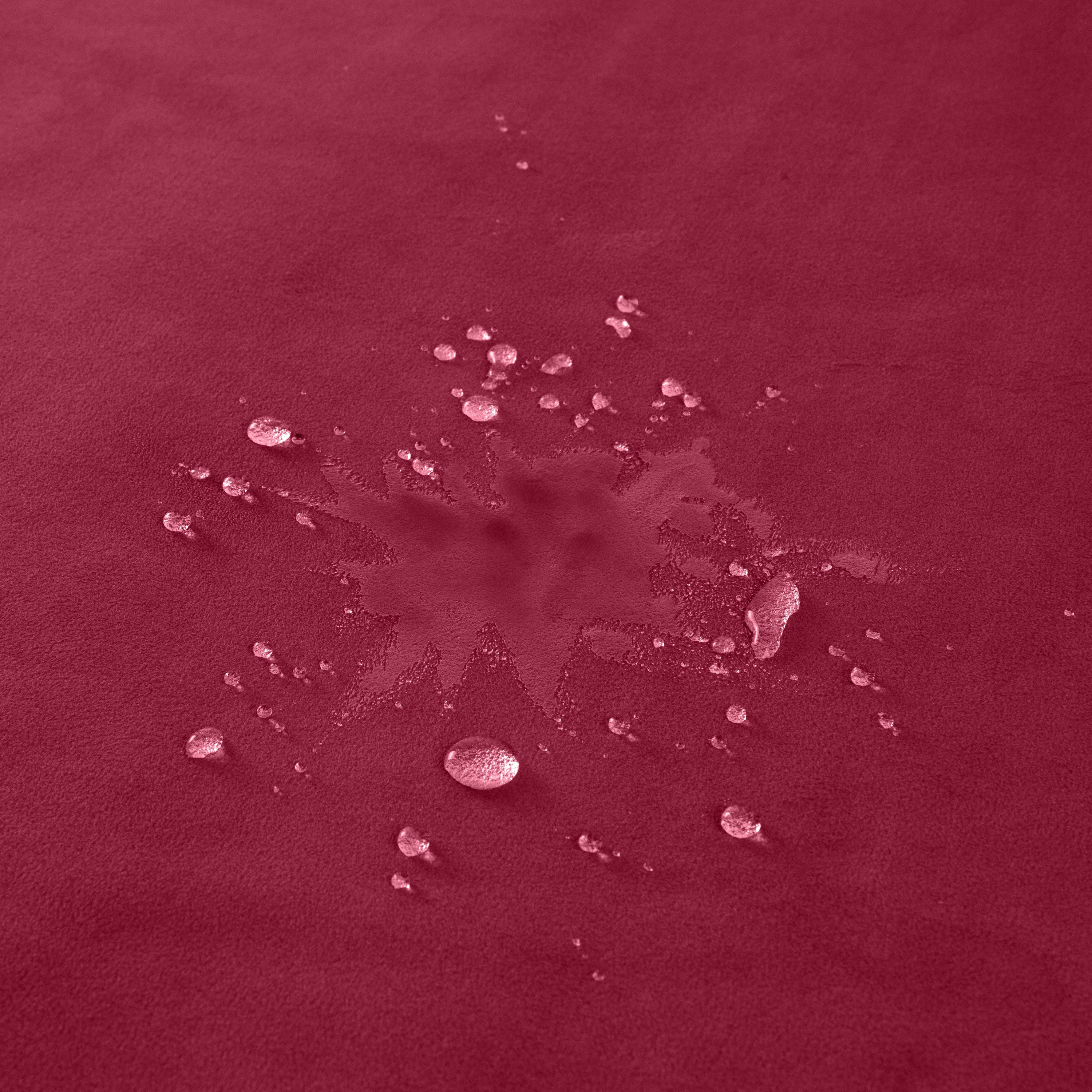 Waterproof microvelvet sex throw in mini merlot with water droplets.