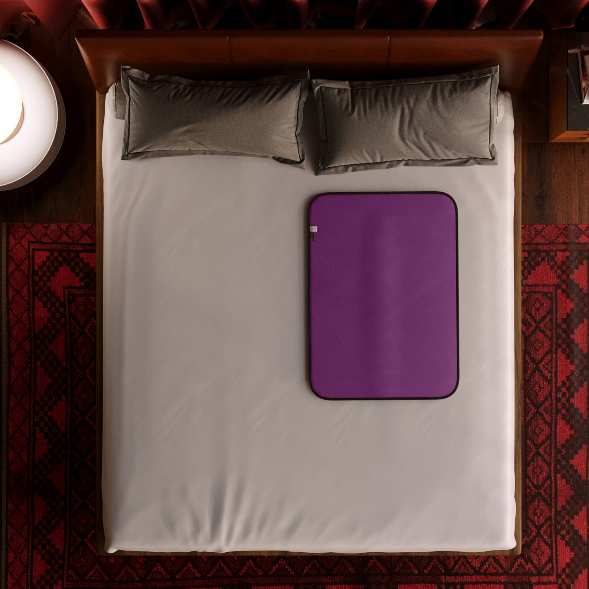 Aubergine microvelvet waterproof sex throw on a bed.