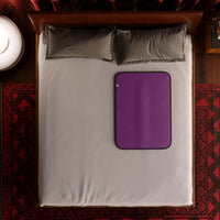 Aubergine microvelvet waterproof sex throw on a bed.