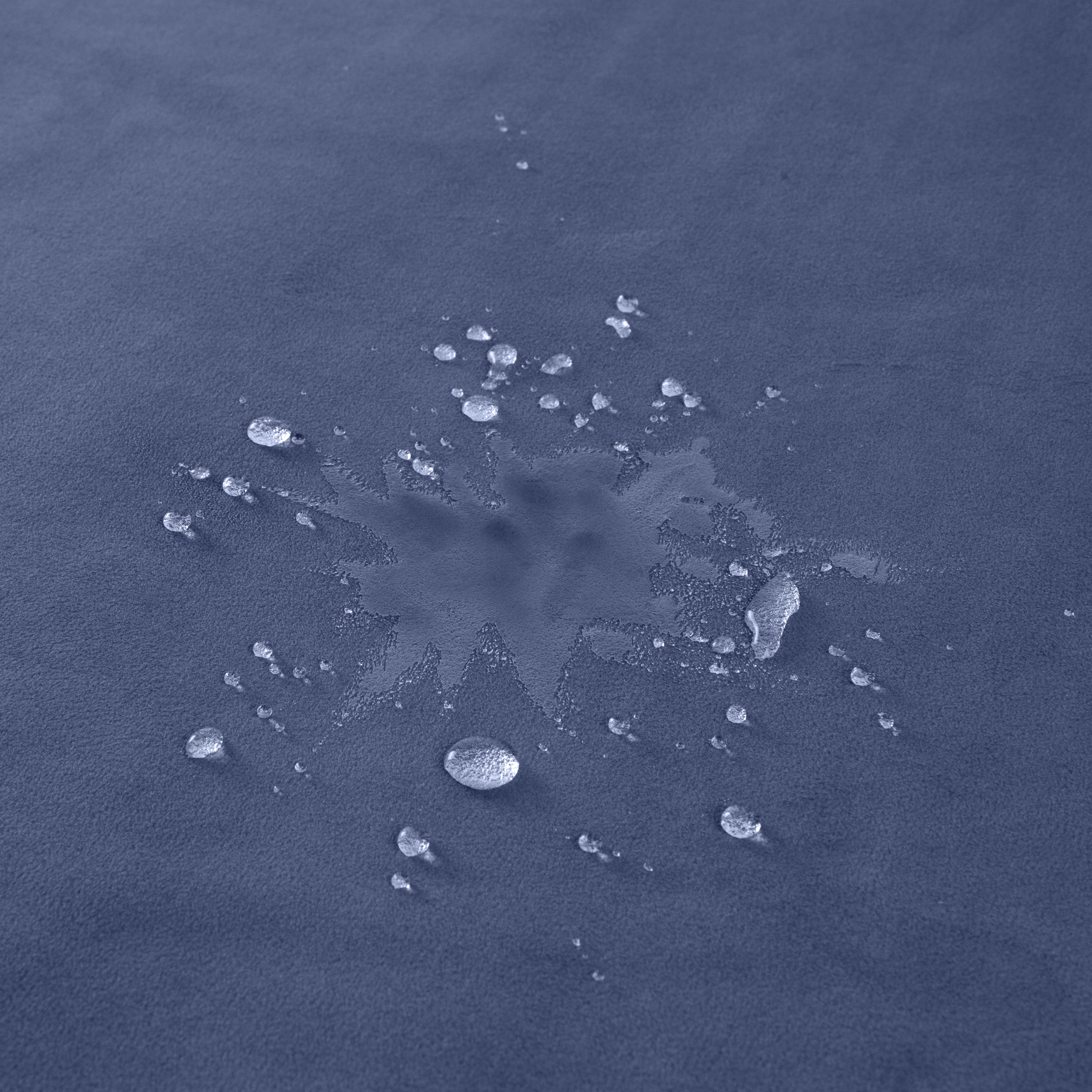 Royal blue waterproof travel throw blanket with water droplets.