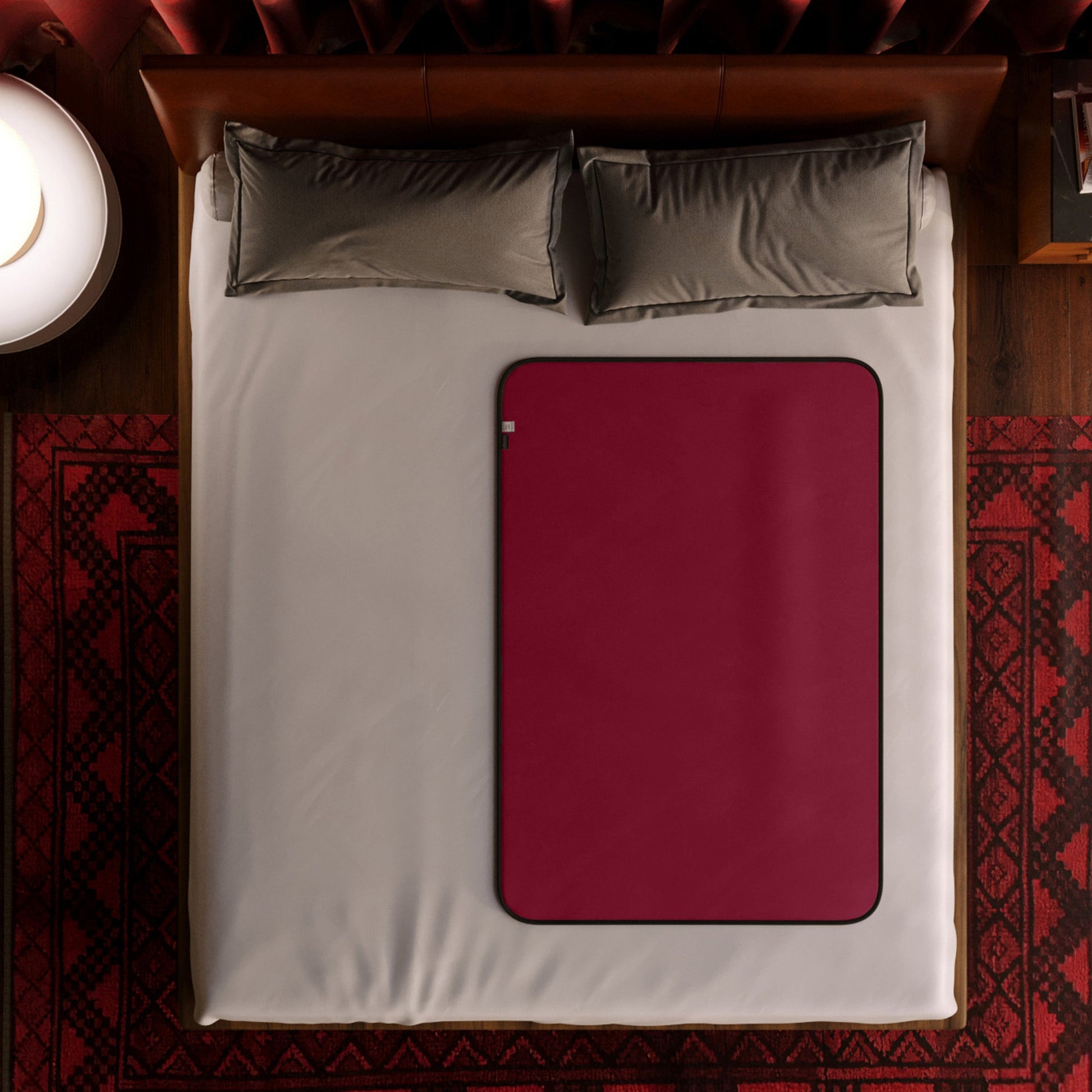 Merlot travel size waterproof microvelvet sex throw on a bed.