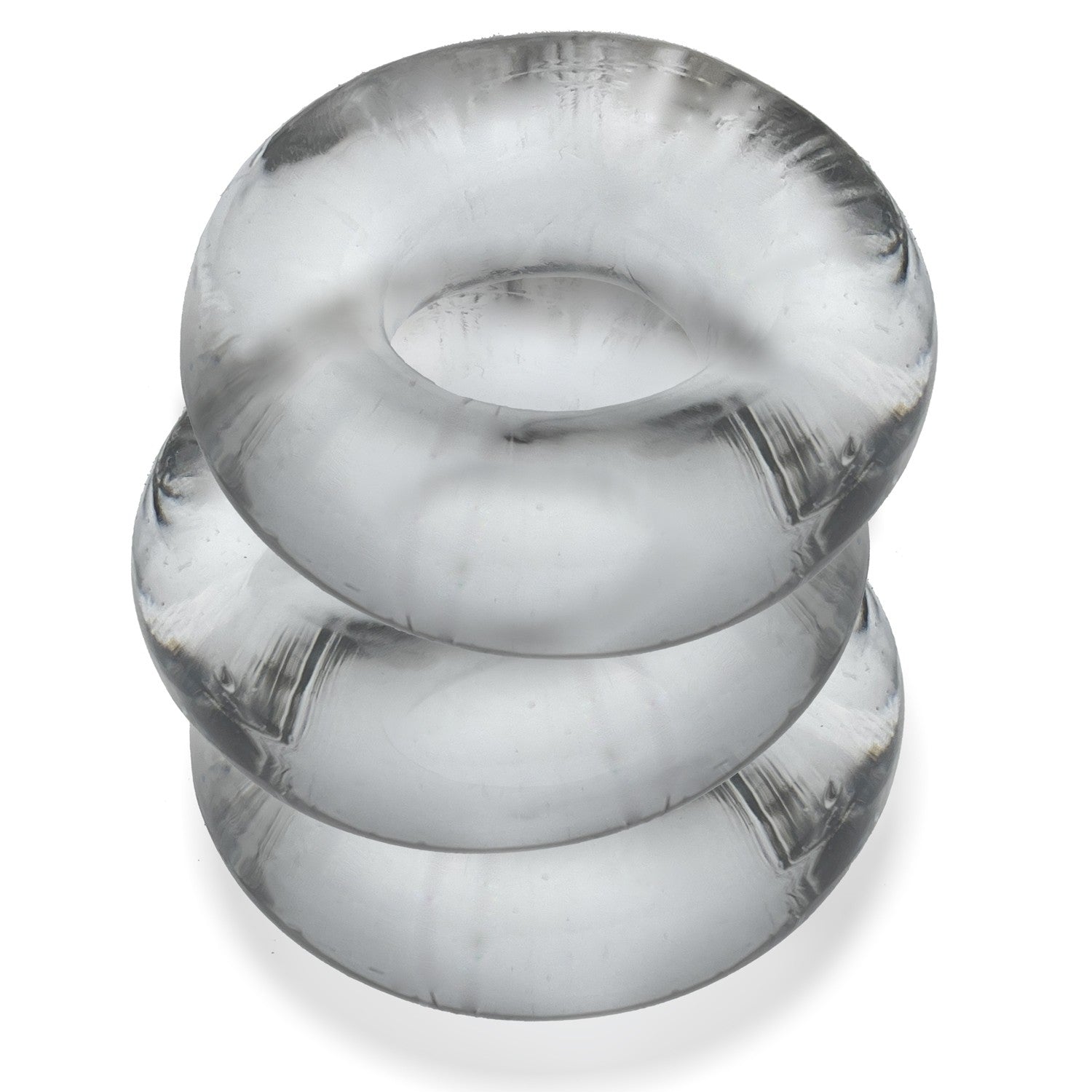 Three clear, flexible cock rings stacked on top of each other.