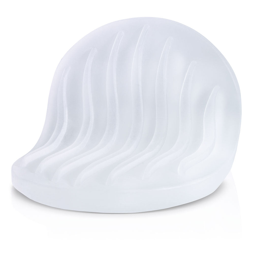 Frosted white textured stroker pad with wavy lines.