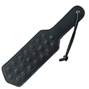 Black leather paddle with metal spikes and a wrist strap.