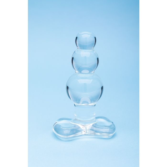 A clear glass anal bead toy with three rounded sections and a flared base.