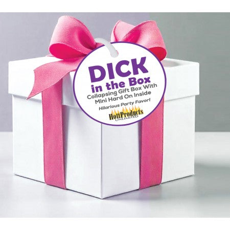 A white gift box with a pink ribbon and a tag that says "Dick in the Box".