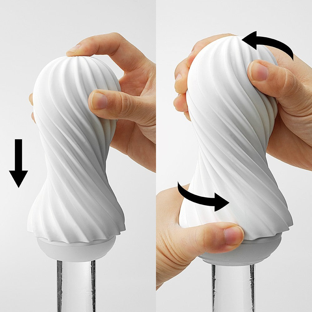 A white spiral stroker being squeezed and pushed down.