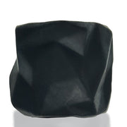 A black, irregularly shaped silicone object with a matte finish.