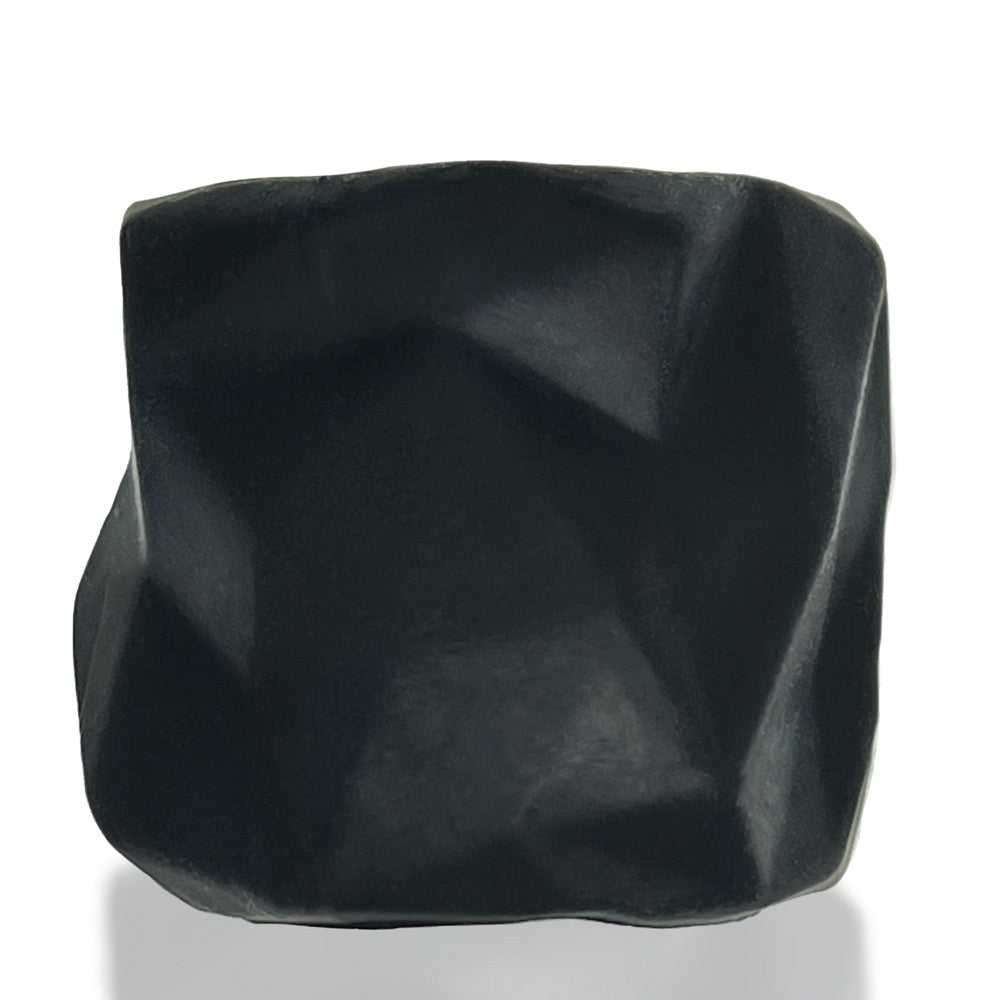 A black, irregularly shaped silicone object with a matte finish.