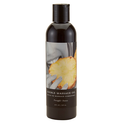 Bottle of pineapple edible massage oil with a picture of a person eating pineapple.