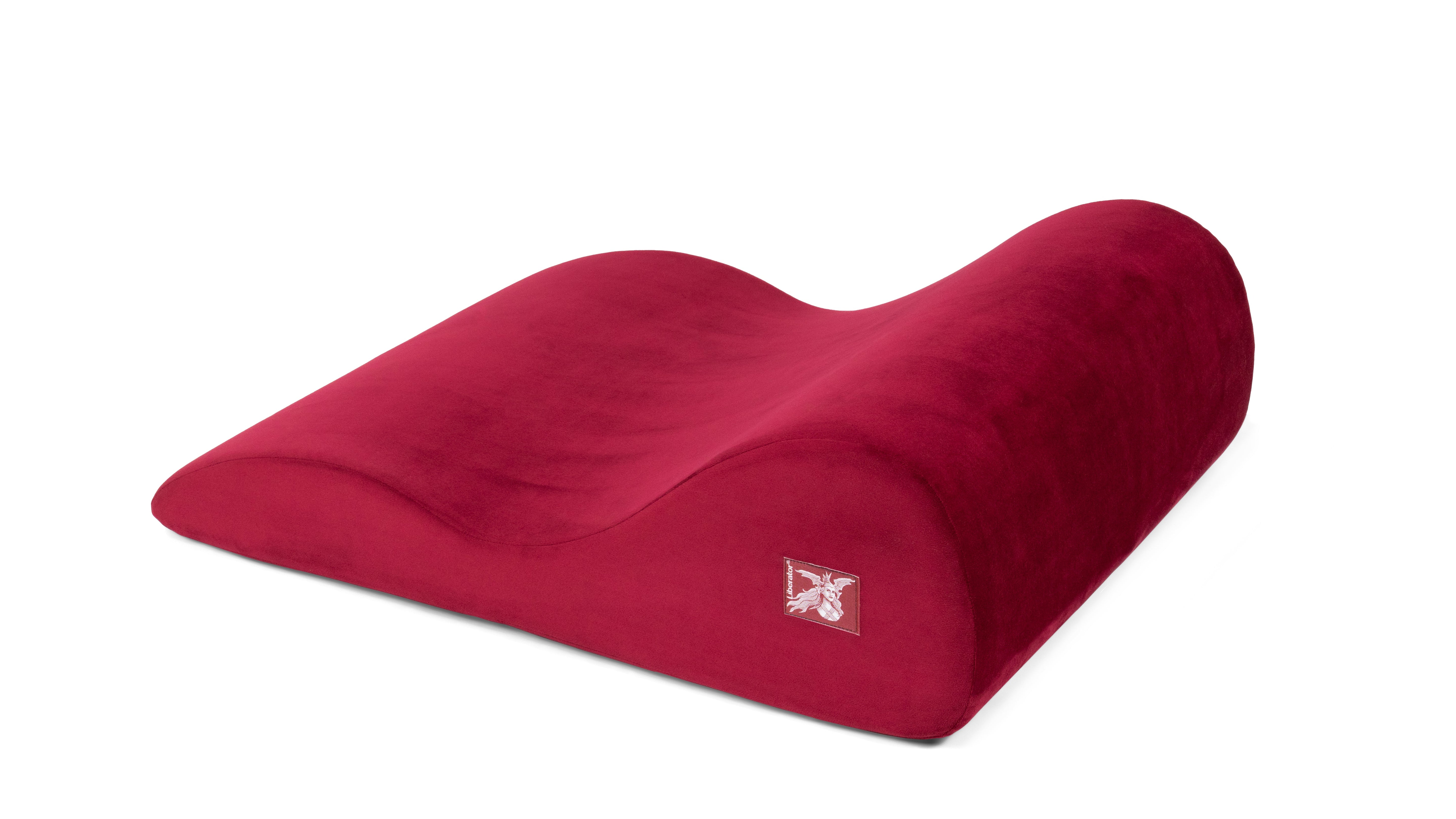A red microvelvet sex wedge pillow with a contoured design and a logo patch.