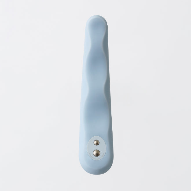 A light blue silicone vibrator with a wavy design and two silver buttons.