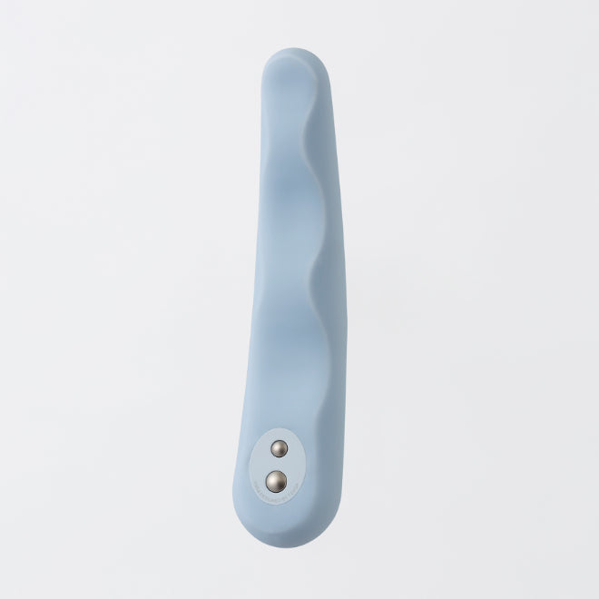 A light blue silicone vibrator with a wavy design and two silver buttons.
