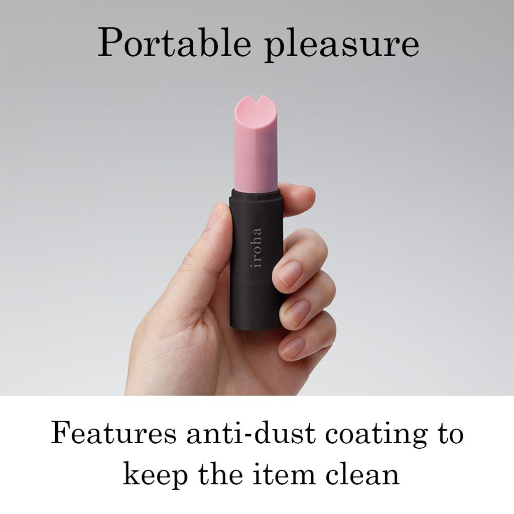 A lilac and black waterproof silicone personal massager held in a hand.