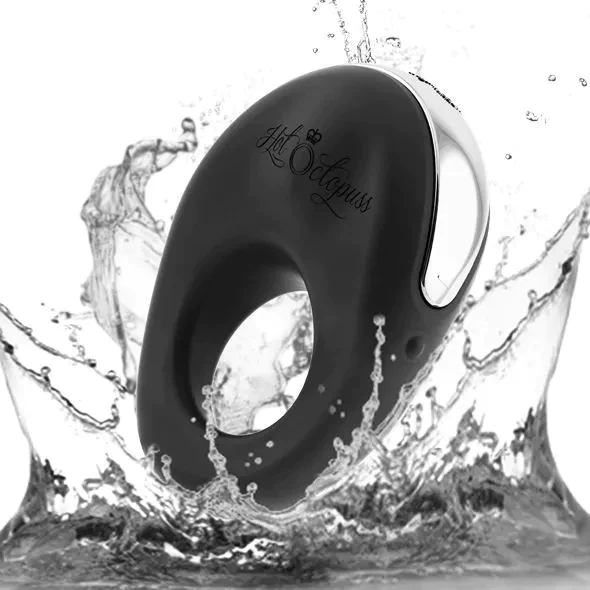 A black vibrating cock ring with a silver accent, partially submerged in water.