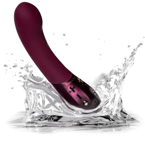 A purple Kurve G-spot vibrator splashing in water.